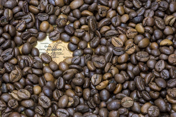 Map of Ecuador under a background of coffee beans — Stok fotoğraf