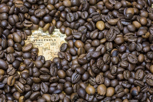 Map of Venezuela under a background of coffee beans — Stockfoto