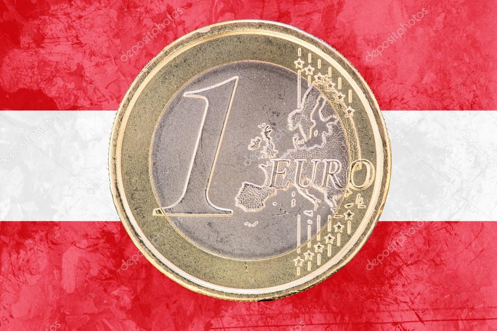 One euro coin on the flag of Austria as background
