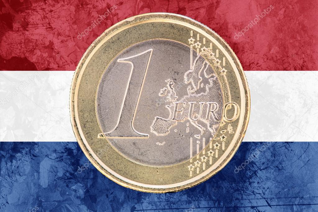 One euro coin on the flag of Netherlands as background