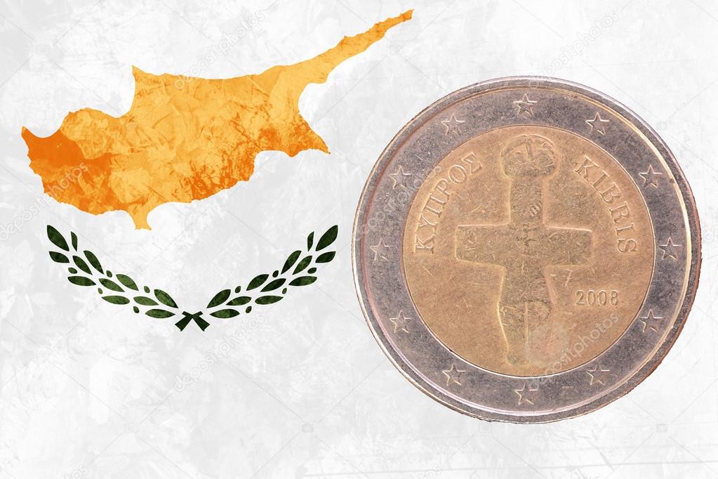 Cypriot two euros coin with flag of Cyprus as background
