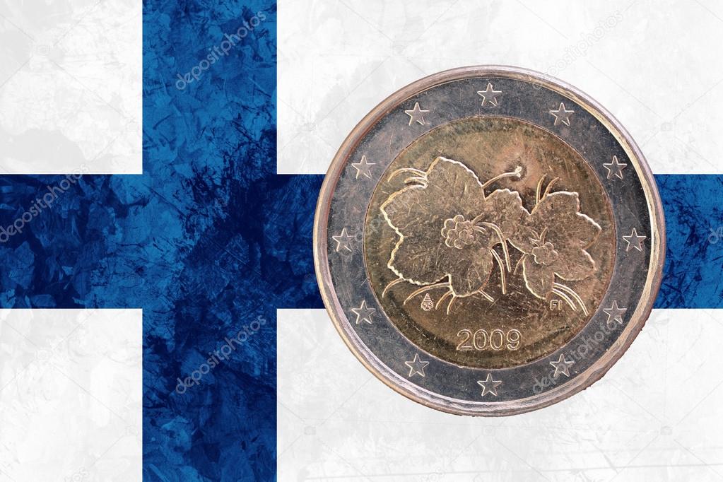 Finnish two euros coin with flag of Finland as background