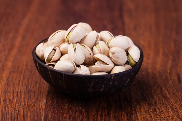 Pistachio nuts. on a wooden table — Stock Photo, Image