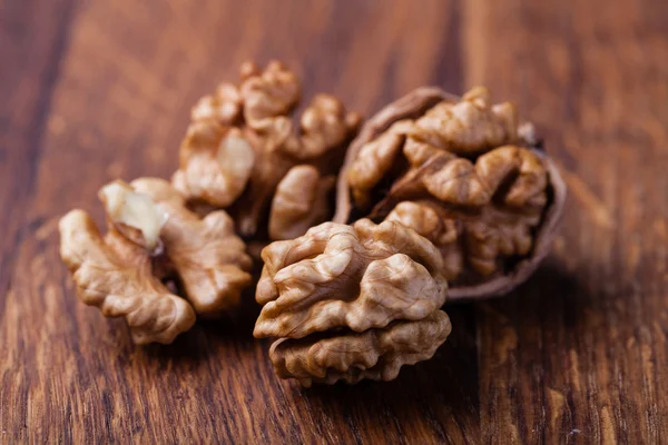 Nueces aisladas sobre una mesa de madera — Foto de Stock