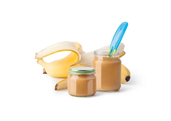 Vasetto con banana baby food e cucchiaio isolato su bianco — Foto Stock