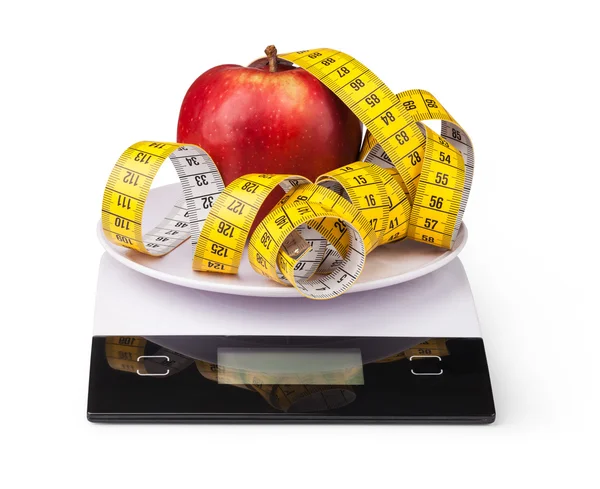 Apple with measuring tape on a digital kitchen scale — Stock Photo, Image