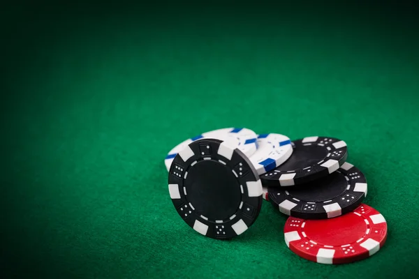 Casino chips on the green table — Stock Photo, Image