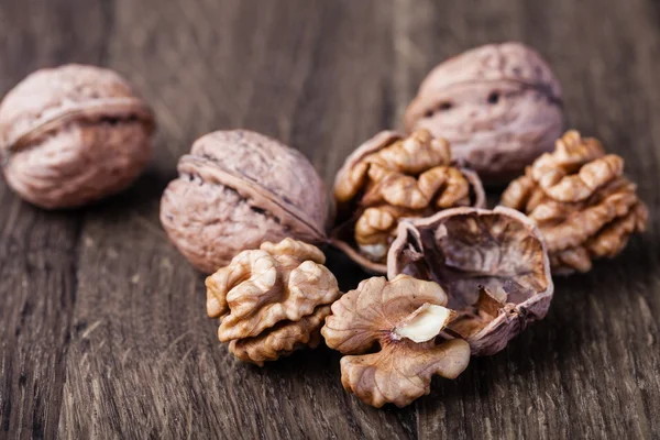 Walnuts isolated on a wooden table — Stock Photo, Image