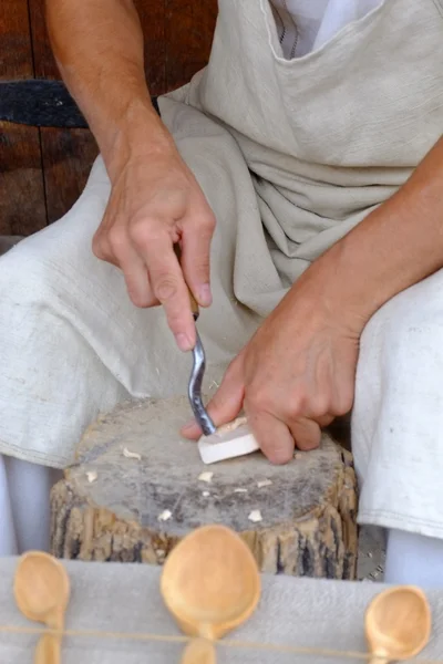 Hands of the craftsman carve a wooden spoon a goug — Stock Photo, Image