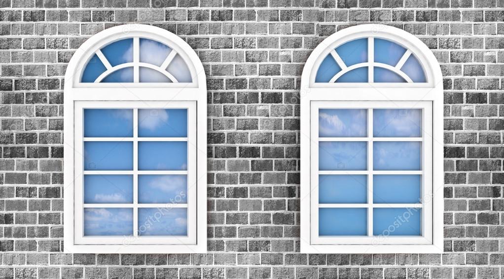 3d windows on the brick wall, with the reflection of the sky in them