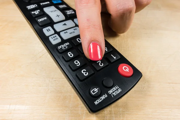 Remote control, woman hand Stock Image