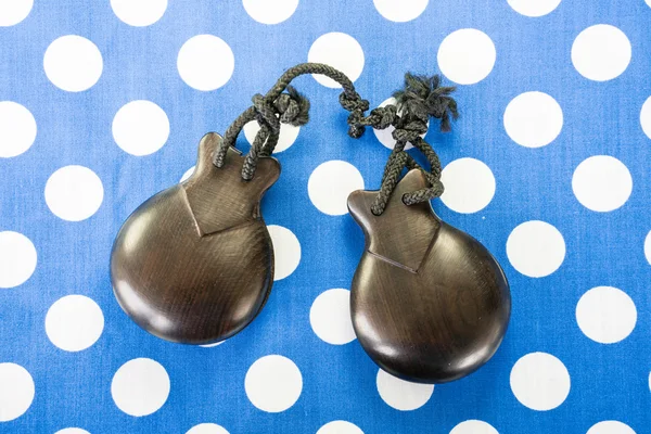 Castanets, blue dotted background — Stock Photo, Image