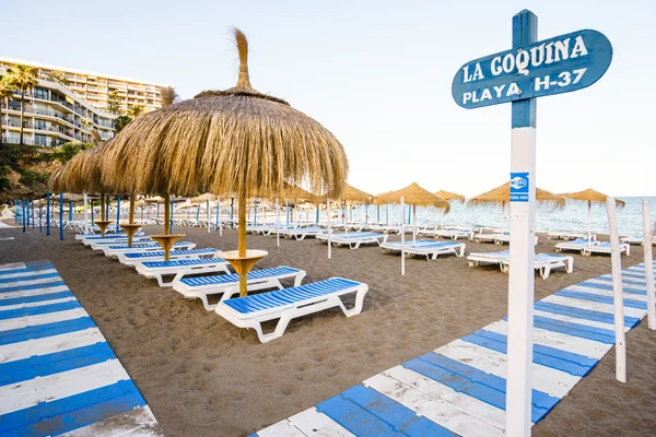 Beautiful beach with deckchairs and umbrellas against of blue sky — Stock Photo, Image