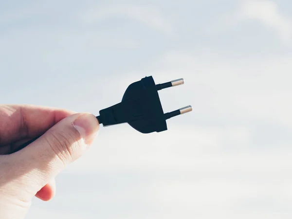 Man Holding Black Plug — Stock Photo, Image