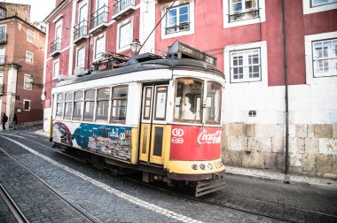 LISBOA, PORTUGAL - NOVEMBER 28: Traditional yellow tram/funicular on November 28, 2013 in Lisbon, Portugal. Carris is a public transportation company operates Lisbon's buses, trams, and funiculars.