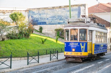 LISBOA, PORTUGAL - NOVEMBER 28: Traditional yellow tram/funicular on November 28, 2013 in Lisbon, Portugal. Carris is a public transportation company operates Lisbon's buses, trams, and funiculars.