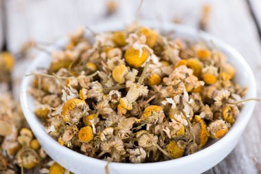 Portion of dried Camomile on table clipart
