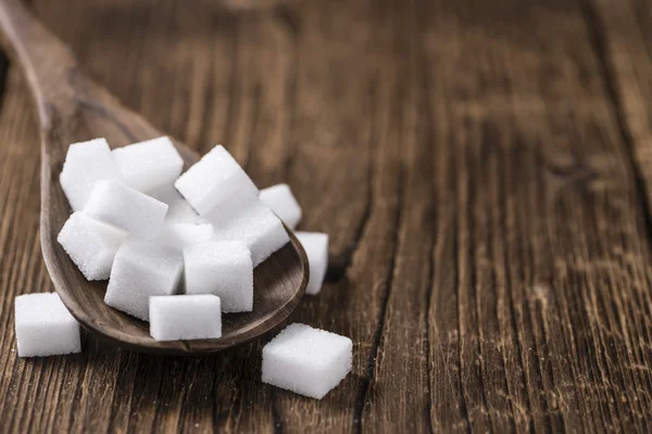 Açúcar branco sobre fundo de madeira — Fotografia de Stock