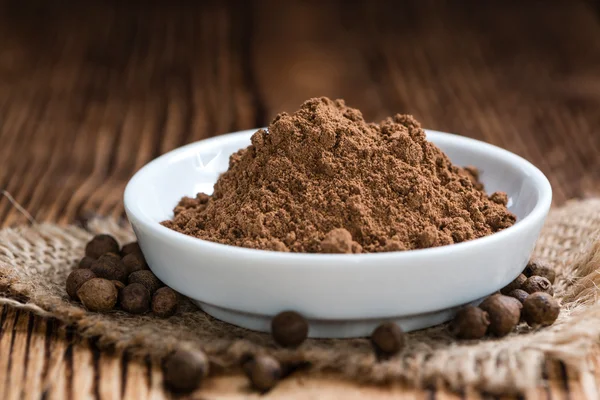 Table with Allspice powder — Stock Photo, Image