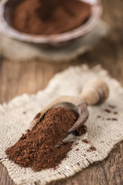 Cocoa powder on wooden background — Stock Photo, Image