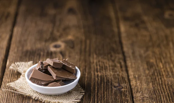Chocolate on an old wooden table — Stock Photo, Image