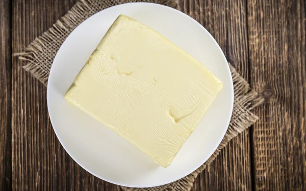 Piece of Butter on table — Stock Photo, Image