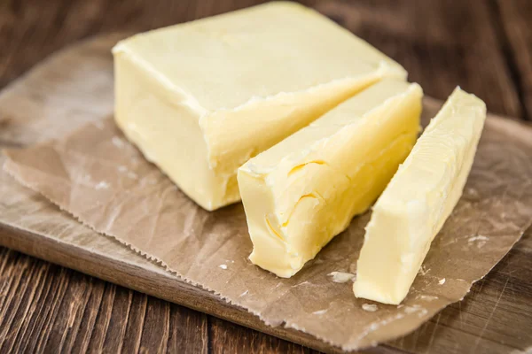 Pieces of Butter on wooden background — Stock Photo, Image