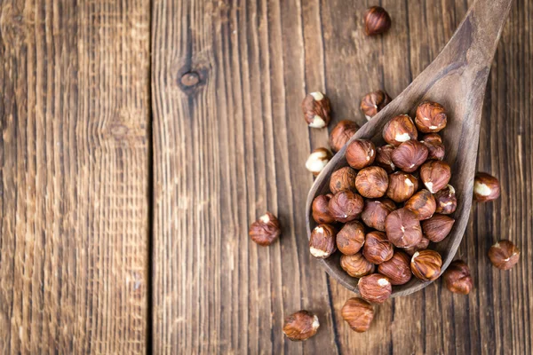 Hazelnuts on wooden spoon — Stock Photo, Image