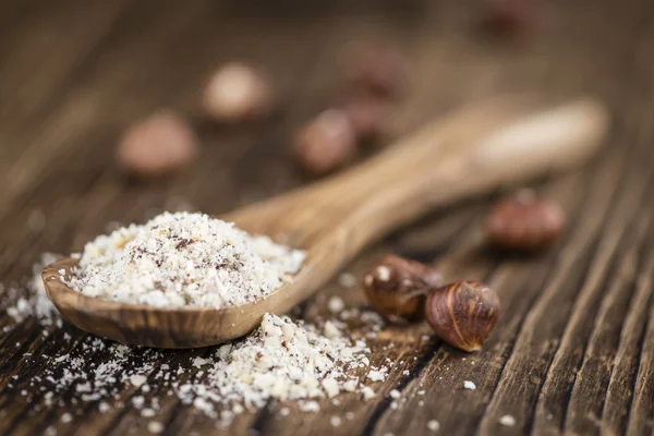 Table with grounded Hazelnuts — Stock Photo, Image