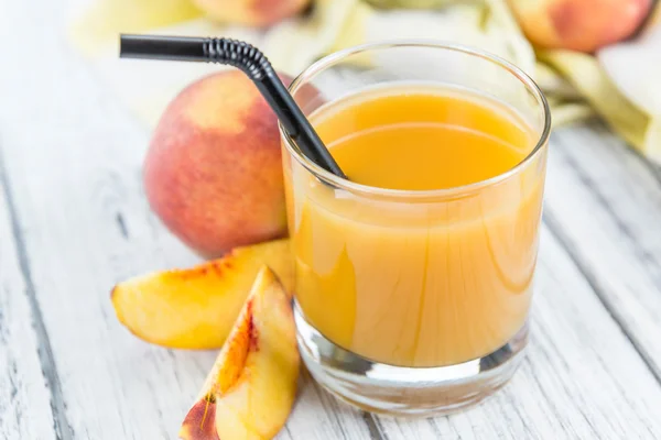 Peach juice on table — Stock Photo, Image