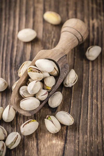 Roasted Pistachios on wooden background — Stock Photo, Image