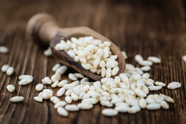 Wooden table with puffed Rice — Stock Photo, Image