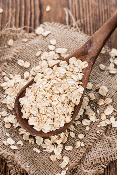 Portion of Oatmeal on wooden spoon — Stock Photo, Image