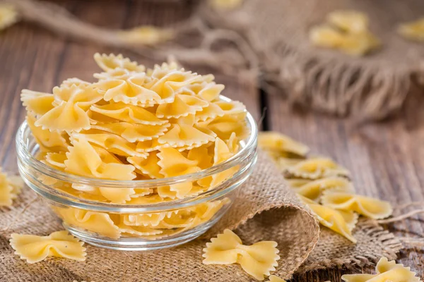 Raw Farfalle on wooden background — Stock Photo, Image