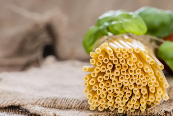 Uncooked Pasta with basil — Stock Photo, Image