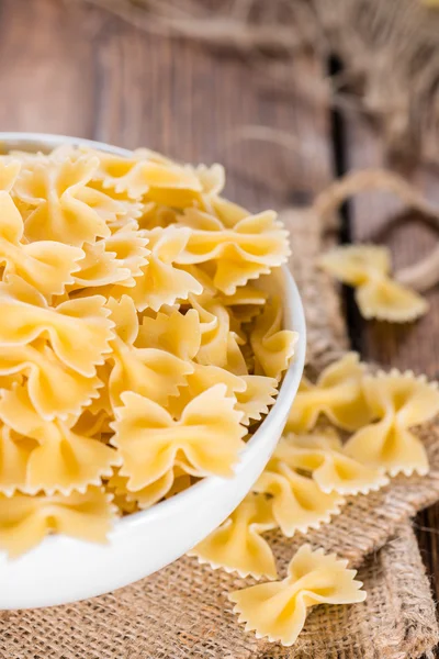 Raw Farfalle (on wooden background) — Stock Photo, Image