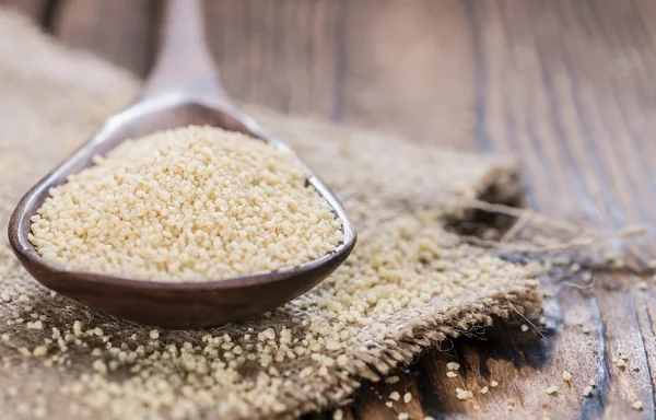 Heap of Couscous in wooden spoon — Stock Photo, Image