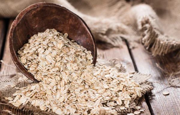 Portion of Oat in wooden bowl — Stock Photo, Image