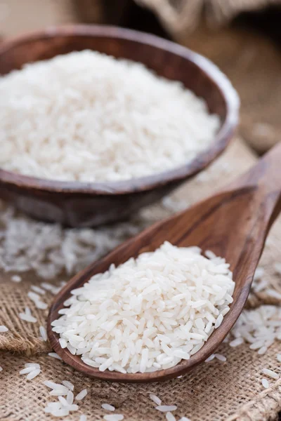 Basmati rice on wooden spoon and in bowl — Stock Photo, Image