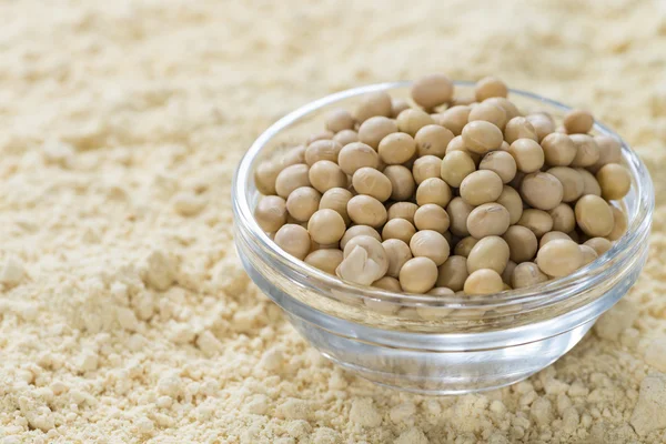 Soy beans on soy flour background — Stock Photo, Image