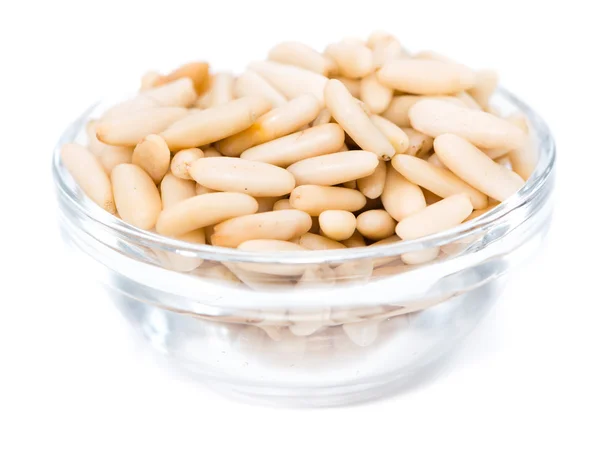 Pine Nuts in glass bowl on white — Stock Photo, Image