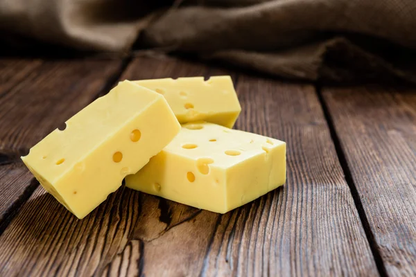 Portion of Cheese on wooden background — Stock Photo, Image