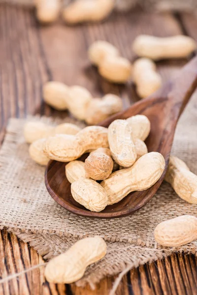 Some Peanuts on a wooden spoon — Stock Photo, Image