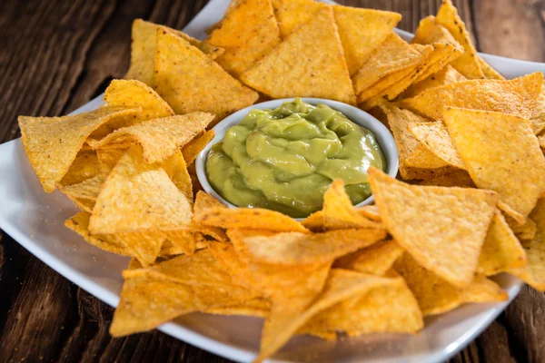 Some Nachos with Guacamole on wooden table — Stok fotoğraf