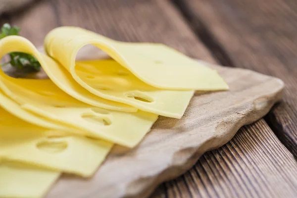 Sliced Cheese on vintage background — Stock Fotó