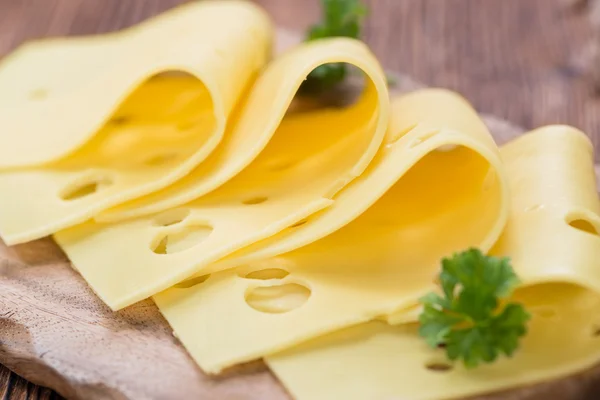 Sliced Cheese on wooden background — Stock Photo, Image