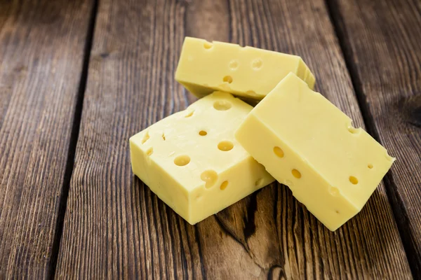 Cheese on vintage wooden background — Stock fotografie