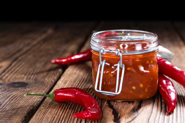 Chili Sauce on rustic wood — Stock Photo, Image