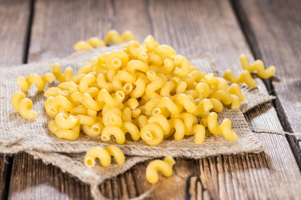 Pasta Curls on dark wooden background — Stockfoto