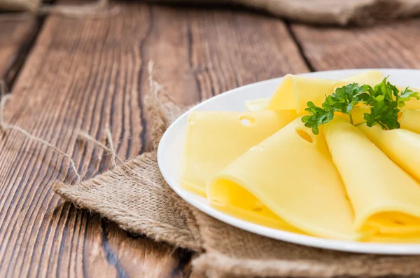 Sliced Cheese on wooden background — Stock Photo, Image